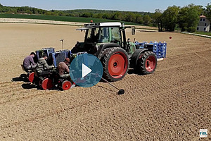 Un tracteur sur un champs, au milieu un bouton pour démarrer le film