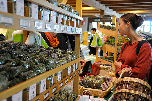 UNe femme dans un magasin devant un étalage d'épices