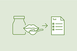 Une bouteille et une bouche tenant une cuillère de test sont représentées sur une feuille de papier portant l'inscription « Test ».