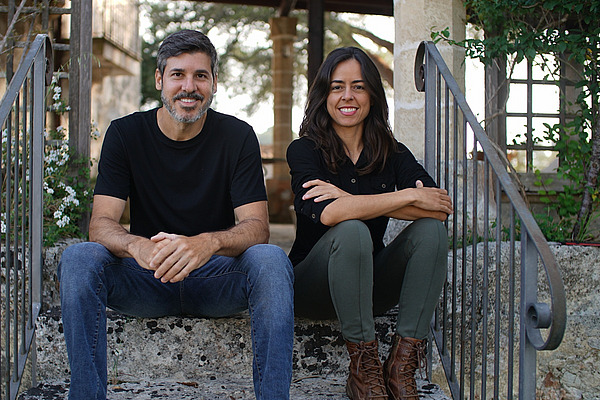 Un homme et une femme assis sur un escalier à l'extérieur.
